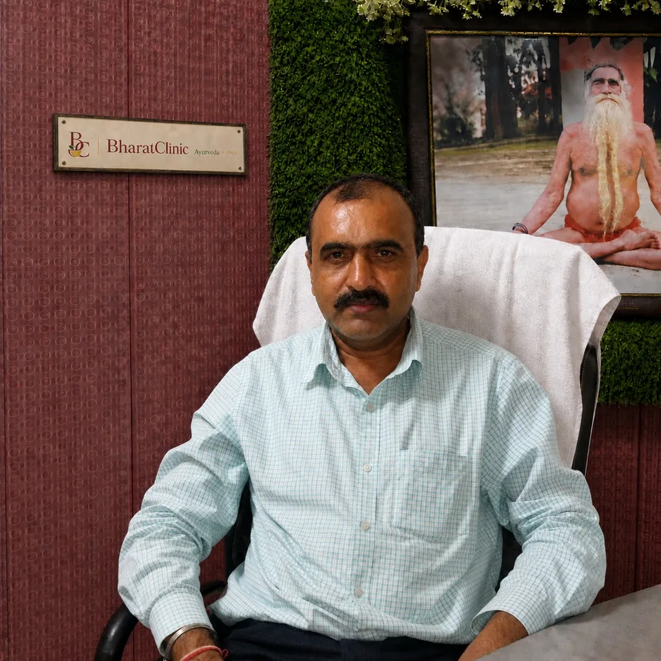 Dr. D. K. Sharma seated in his consultation room at Bharat Clinic